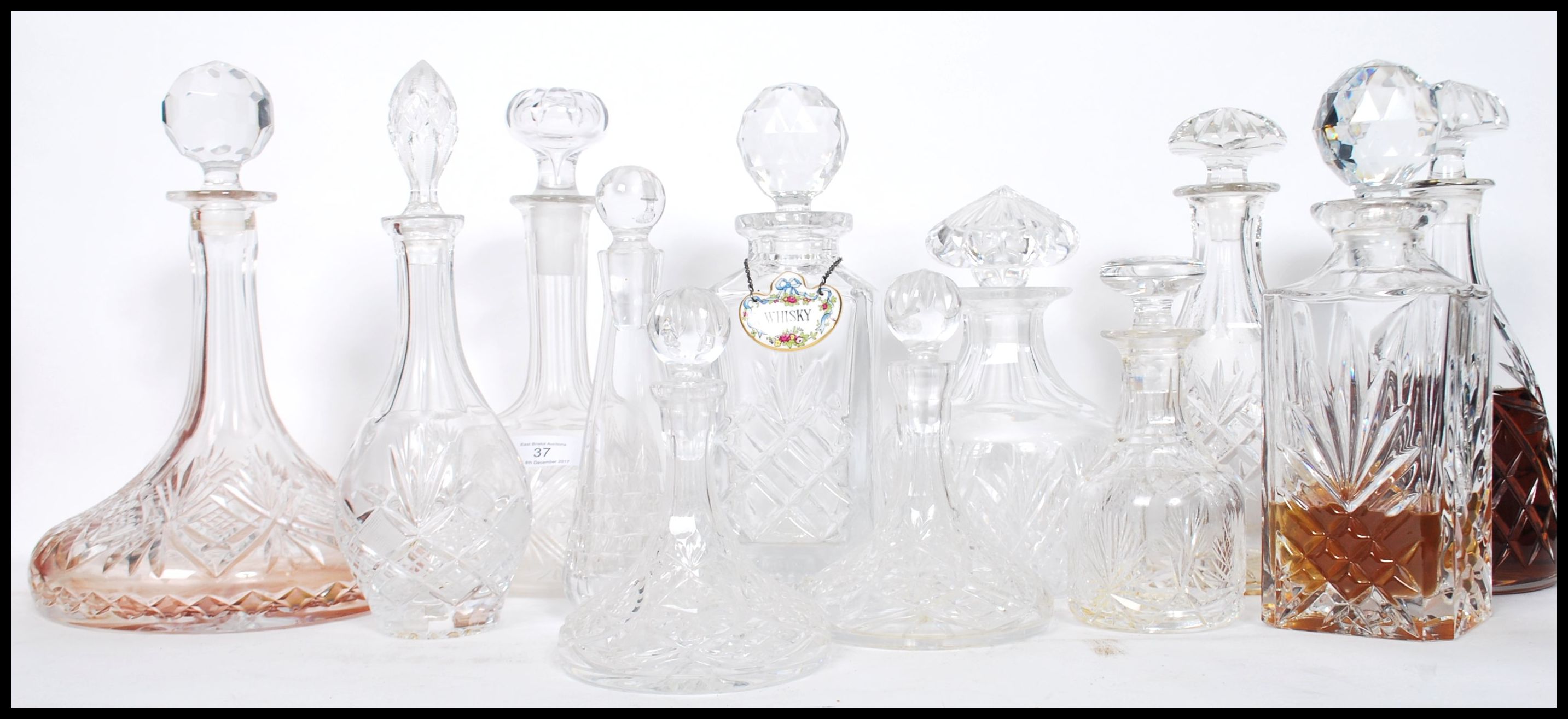 A good collection of vintage early and later 20th century cut glass lead decanters to include a