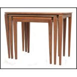 A 1970's Danish inspired teak wood nest of tables, having shaped tops raised on square tapered legs.