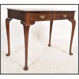 A Victorian style mahogany writing table raised on pad feet with cabriolet legs with leather gilt