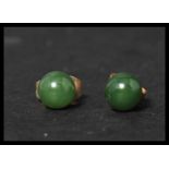 A pair of vintage 9ct gold and jade stud earrings. Jade stone beads set to gold post backs. Weighs