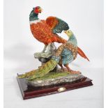A large hunting interest figural group depicting a brace of pheasants set to a naturalistic base