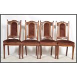 A set of 4 Edwardian high back mahogany dining chairs in the Arts & Crafts style being raised on