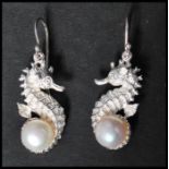 A pair of 925 silver drop earrings in the form of seahorses set with pearls having fish hook