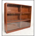 A vintage 20th century mahogany lawyers stacking bookcase cabinet of sectional form with glass facia