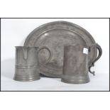 A group of 19th century pewter metal ware to include a VR stamped with side handle and