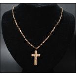 A hallmarked 9ct gold crucifix pendant set on a 9ct gold belcher link chain. The cross having an