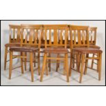 A set of 7 20th century beech wood chapel chairs. Each with turned legs united by stretchers,