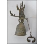 A cast brass wall bell Renaissance Revival style cast brass wall bell decorated with a band of