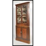 A 19th century country house Fruitwood corner unit display cabinet having astral glazed doors with