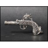 A 925 silver novelty pendant in the form of an ornate pistol with bale. Marked London 1795 Sterling.