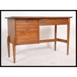 A retro 20th century  Danish teak wood single pedestal desk with an arrangement of three drawers