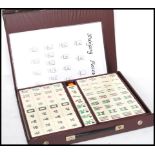 A vintage 20th century Chinese Oriental Mahjong set having ceramic pieces contained within a