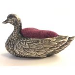 A hallmarked early 20th century silver figural pincushion in the form of a swan having a purple