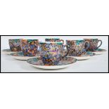 An early 20th century Art Deco set of six coffee cups / cans and saucers having a multi coloured