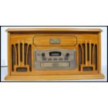 A contemporary antique style hi-fi system in wooden case with radio, record player, cassette player,