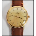 A vintage 20th century Omega watch set to a brown leather strap. The gilt dial having baton numerals