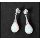 A pair of 925 silver opal pear shape drop earrings having a pierced style setting with post backs.