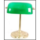 20th century green glass and brass bankers desk lamp having glass rectangular shades raised on