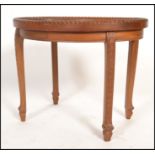 An unusual early 20th century Chinese carved side table. Raised on shaped legs with oval table top