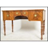 A 19th century mahogany inverted breakfront desk, tooled red leather top above a series of drawers