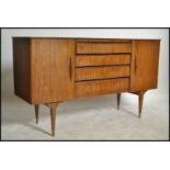 A 1950's - mid century retro sideboard dresser of low and wide form having tapering supports