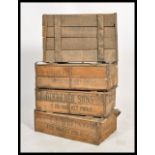 A stack of four vintage 20th century wooden fish shipping crates, notation to the sides and tops