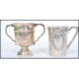 A silver hallmarked trophy cup along with an 800 silver toddy cup. The trophy having a circular base