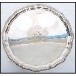 A Silver hallmarked Salver, with bead border raised on four ball and claw pad  feet, possibly with