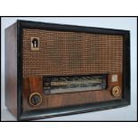 A vintage 1940's walnut cased Cossor Melody Master 523 valve radio with decorative dial and facia