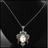 A 925 silver Art Nouveau style pendant necklace strung with figural pendant of a lady set with