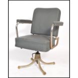 A vintage retro mid 20th century industrial office swivel chair of tubular construction raised on