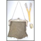 An Edwardian silver white metal mesh evening bag,  fine mesh work square bag below reticulated