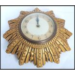 A vintage mid 20th century retro Smiths sunburst wall clock. The two tone dial having arabic