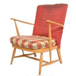 An unusual mid century Ercol armchair being raised on turned legs united by stretchers having