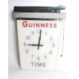 A vintage early 20th century Guinness electric glass and chrome wall clock having a chrome light