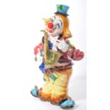 A fantastic 20th century ceramic floor standing clown, finished with an enamel glaze, the clown