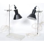 A pair of vintage retro 20th century industrial desk lamps having black enamel pendant shades