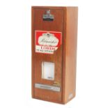 A mid century mahogany shop pub club cigar dispenser of rectangular form with wall mounting having