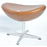 After Arne Jacobsen. A polished steel and tan brown leather upholstered egg stool - foot stool.
