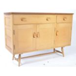 A 1950's mid century Ercol ' Windsor ' pattern beech and elm sideboard having two drawers above