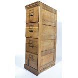 A good early 20th century Industrial oak upright pedestal 4 drawer filing cabinet having plinth base