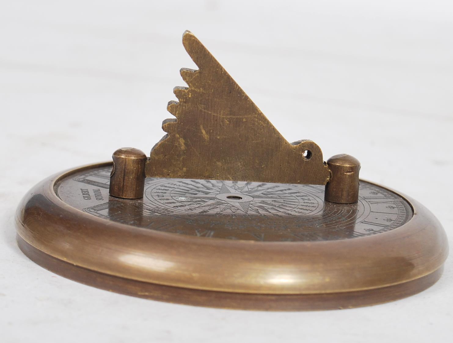 An unusual 20th century Gilbert Sundial - brass pocked cased sundial and compass being of roundel - Image 3 of 5