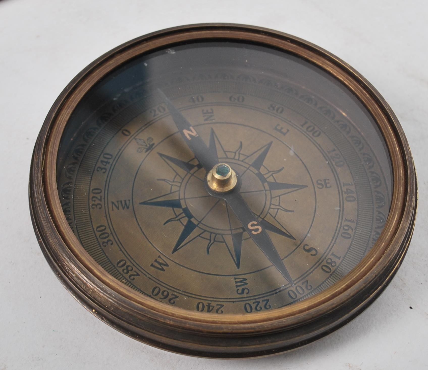 An unusual 20th century Gilbert Sundial - brass pocked cased sundial and compass being of roundel - Image 2 of 5