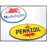 A pair of vintage style cast metal point of sale advertising garage wall plaques for Mobilgas and