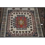 A 20th century Kelim woolen rug, on cream ground with a central medallion, inner border with