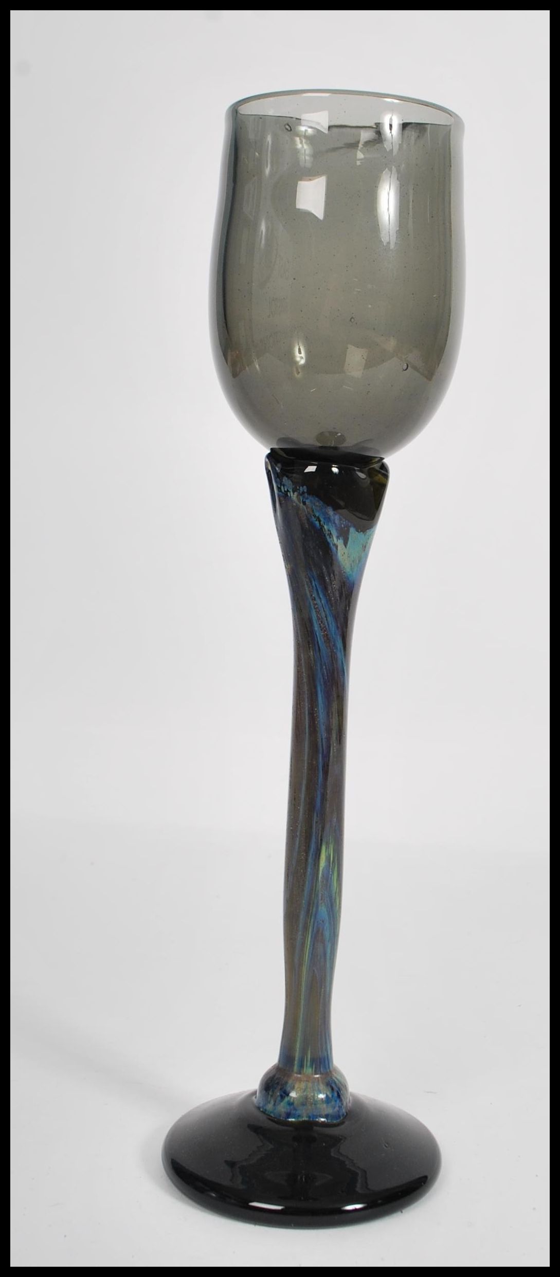 A vintage mid 20th century studio art wine glass raised on circular base with long coloured stem and