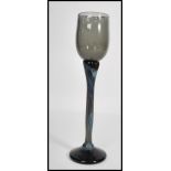 A vintage mid 20th century studio art wine glass raised on circular base with long coloured stem and