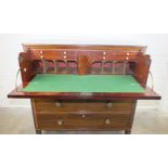 An early 19th century secretaire chest in two parts, the top with reeded edge above a fitted