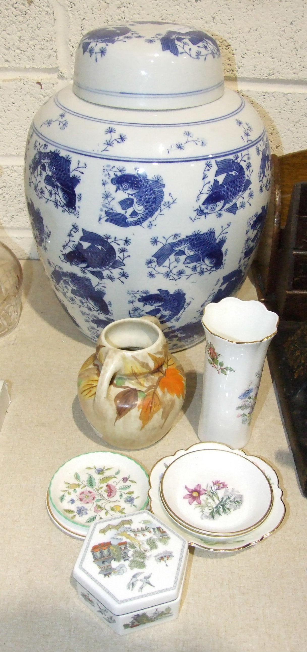 A large reproduction blue and white ginger jar and cover decorated overall with fish, 37cm high, a