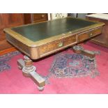 A Victorian oak library table, the rectangular top with writing inset above two frieze drawers and